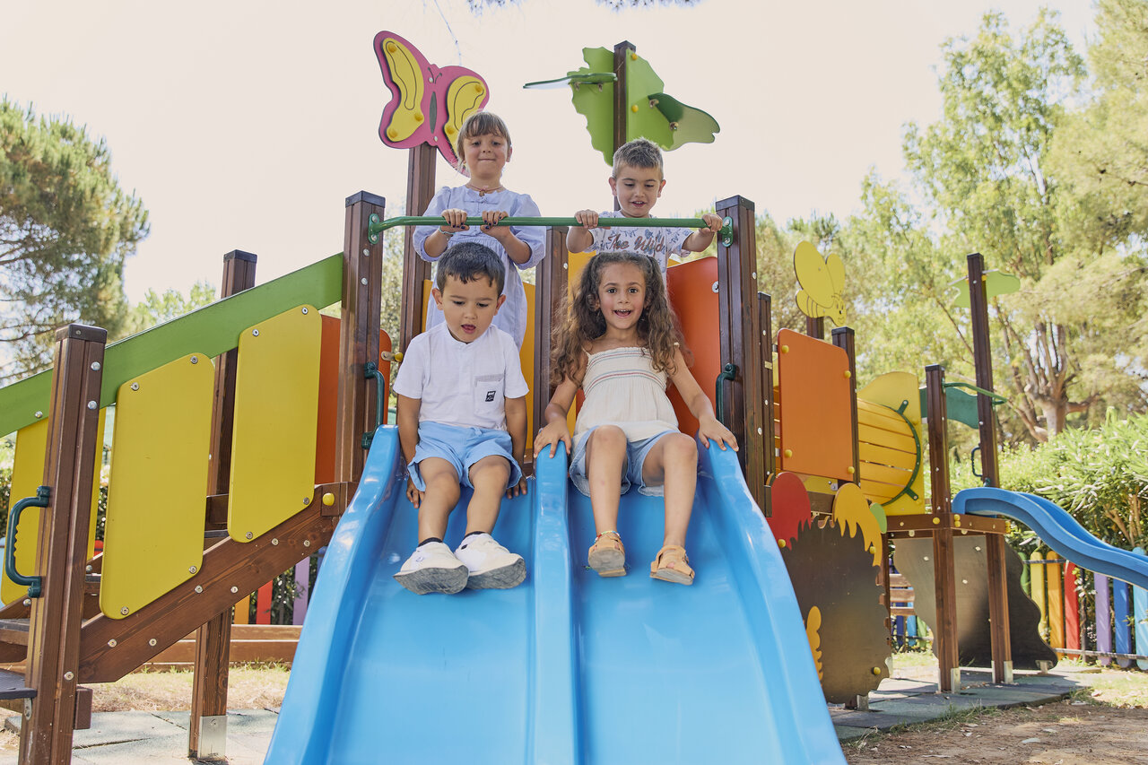Children on slides playground at CAPFUN Campo dei Fiori campsite in Rosignano Marittimo.