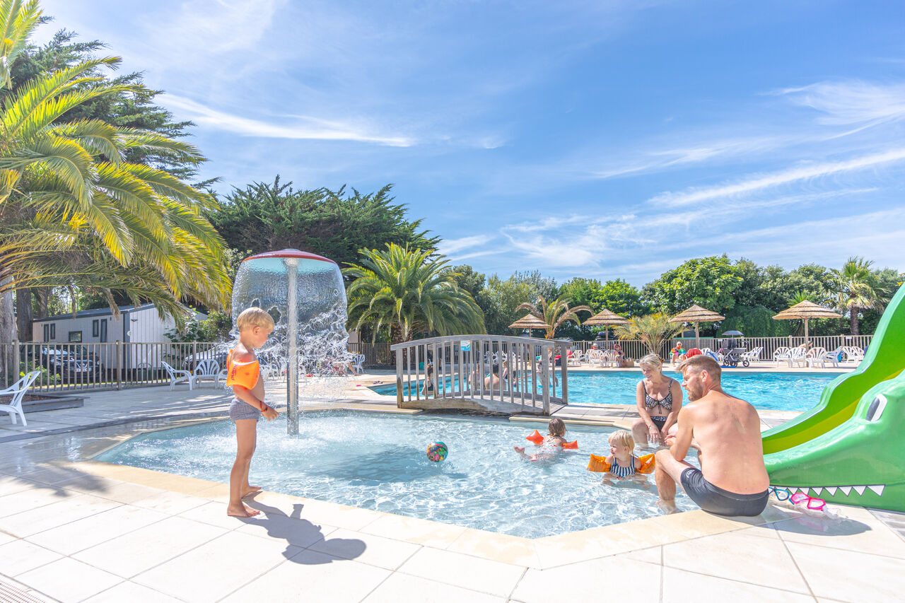 Swimming pool, splash pad, crocodile slide at CLICOCHIC Camp du Soleil, Ars-en-R�.