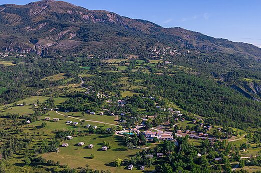 Aerial view campsite, Mobil-homes and mountains at CLICOCHIC Castillon de Provence campsite.