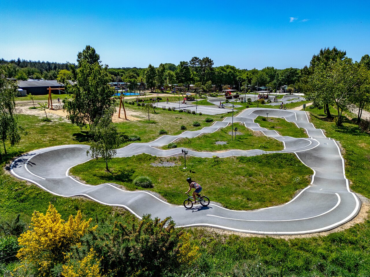 Modern pump track with cyclist, playground at CAPFUN Cenic campsite in PENESTIN (56).