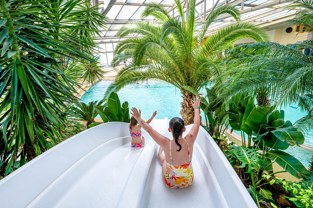 Water slide and indoor pool with children at CAPFUN Cenic campsite in PENESTIN (56).