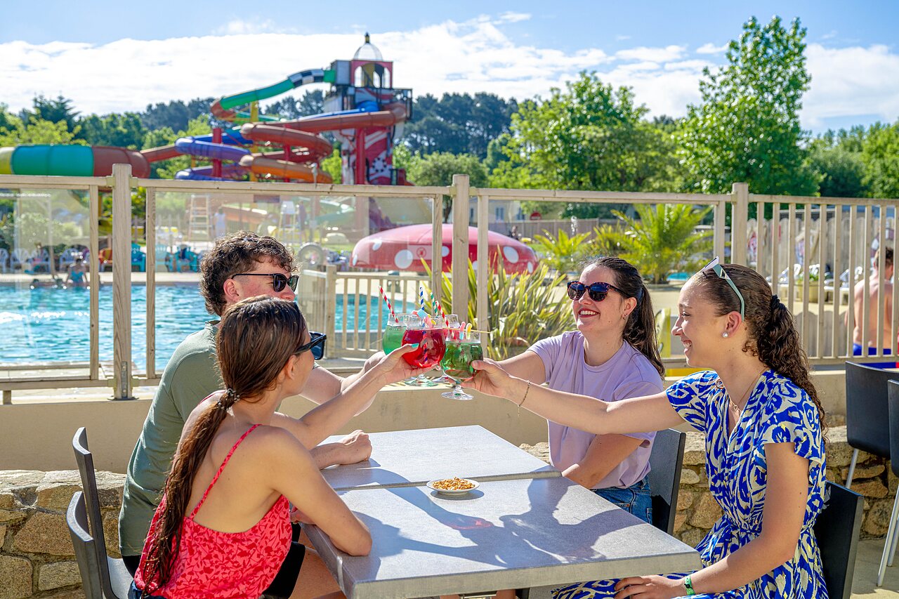 Friends toasting at bar, water slides, CAPFUN Cenic in PENESTIN (56).