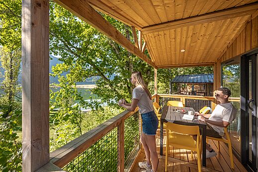 Accommodation terrace with lake and nature view at CLICOCHIC Chancia campsite in Chancia (01).