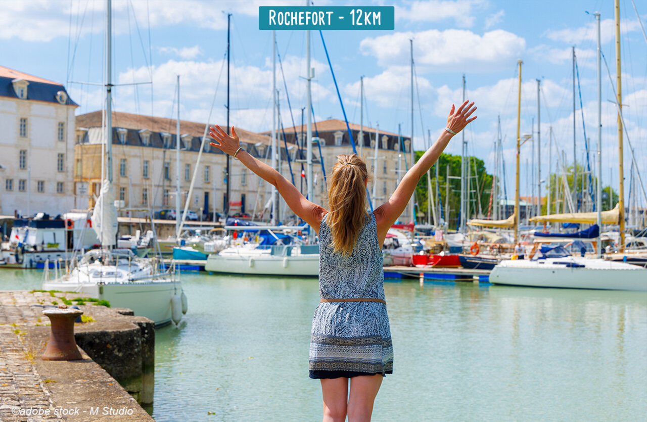 Rochefort marina with sailboats and historic buildings, a must-visit attraction.