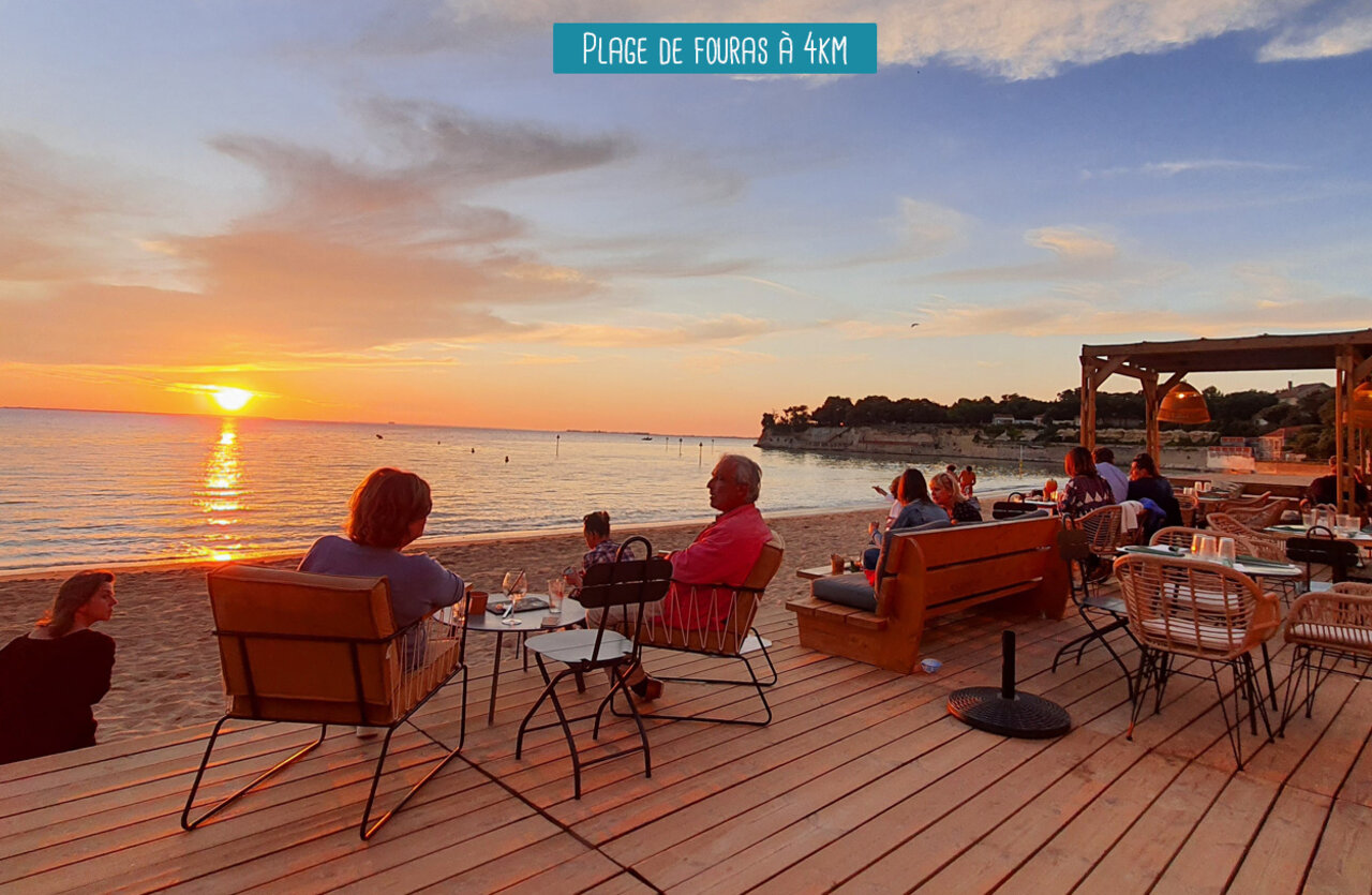 Beach restaurant with wooden terrace at sunset, Plage de Fouras.