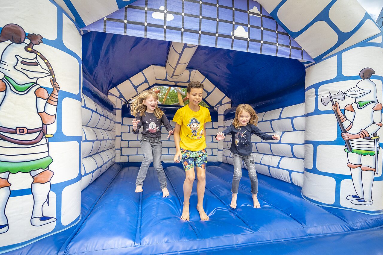 Bouncy castle children at CLICOCHIC Ch�teau de Boisson campsite in All�gre-les-Fumades (30).