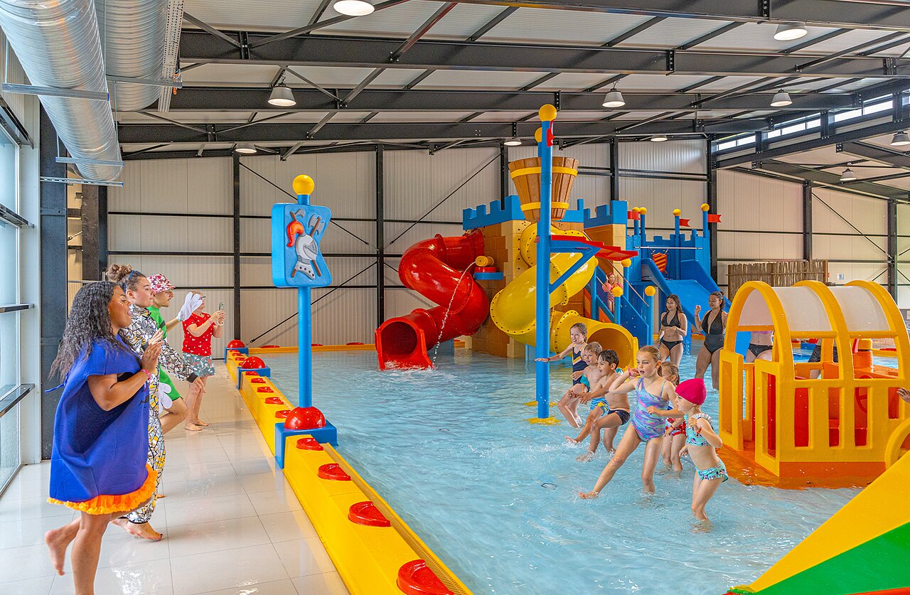 Indoor pool, waterslides, water games, children at CAPFUN Ch�teau de Galin�e campsite.