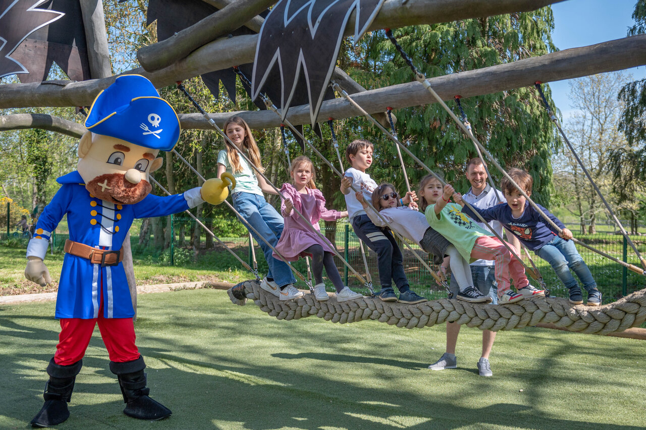 Pirate mascot and children playing on rope bridge at CAPFUN Chateau d'Arvid campsite in Villerville (14).