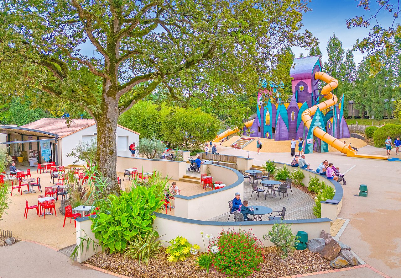 Large castle playground with slides and terrace at CAPFUN La Ch�naie campsite in PORNIC (44).