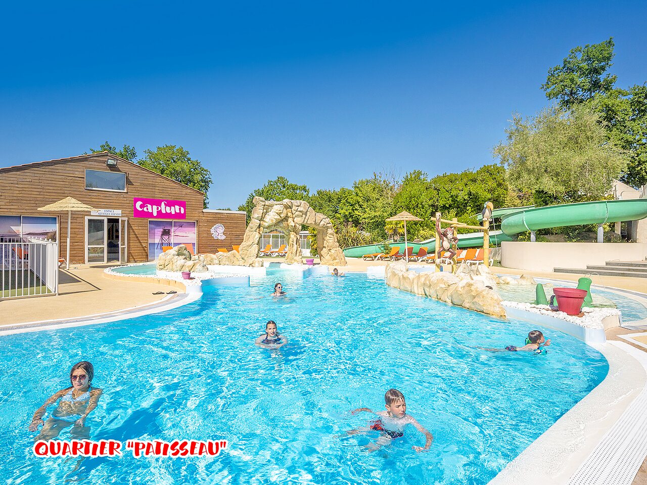 Outdoor pool, water slide, children at CAPFUN La Ch�naie campsite in PORNIC (44).