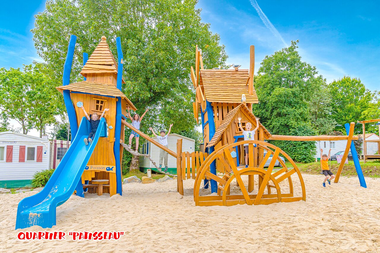 Wooden playground, slide, children at CAPFUN La Ch�naie campsite in PORNIC (44).