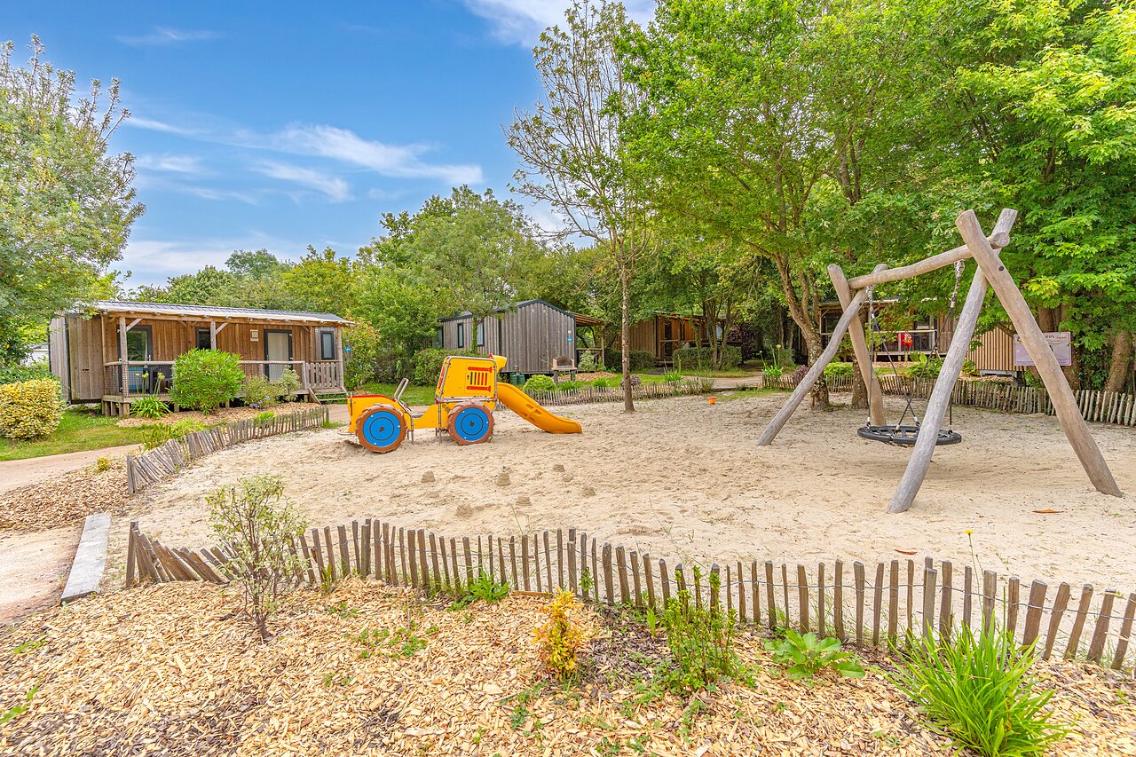 Tractor slide, swing, playground at CAPFUN La Ch�naie campsite in PORNIC (44).