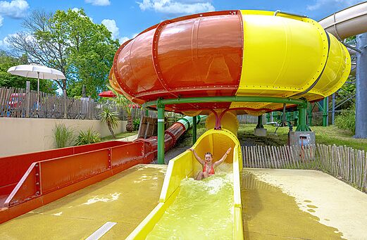 Giant water slide, young woman at CAPFUN La Chênaie campsite in PORNIC.