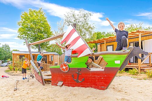 Children playing on pirate ship playground at CAPFUN La Ch�naie campsite in PORNIC.