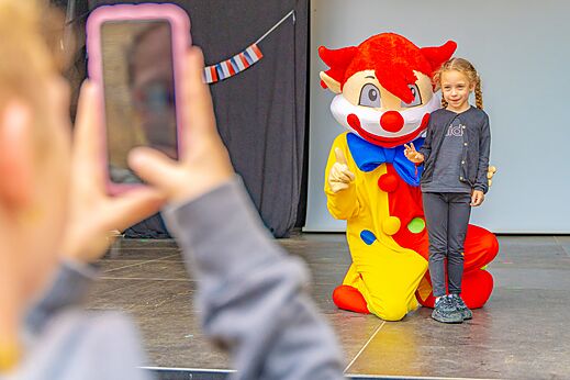 Colorful mascot and child pose for photo at CAPFUN La Ch�naie campsite PORNIC.
