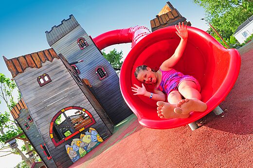 Happy child on red slide of playground at CAPFUN Ch�nes campsite in Medis/Royan (17).
