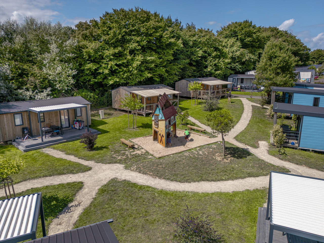 Playground and mobile homes aerial view at CLICOCHIC Chevaliers campsite in HOULGATE (14).