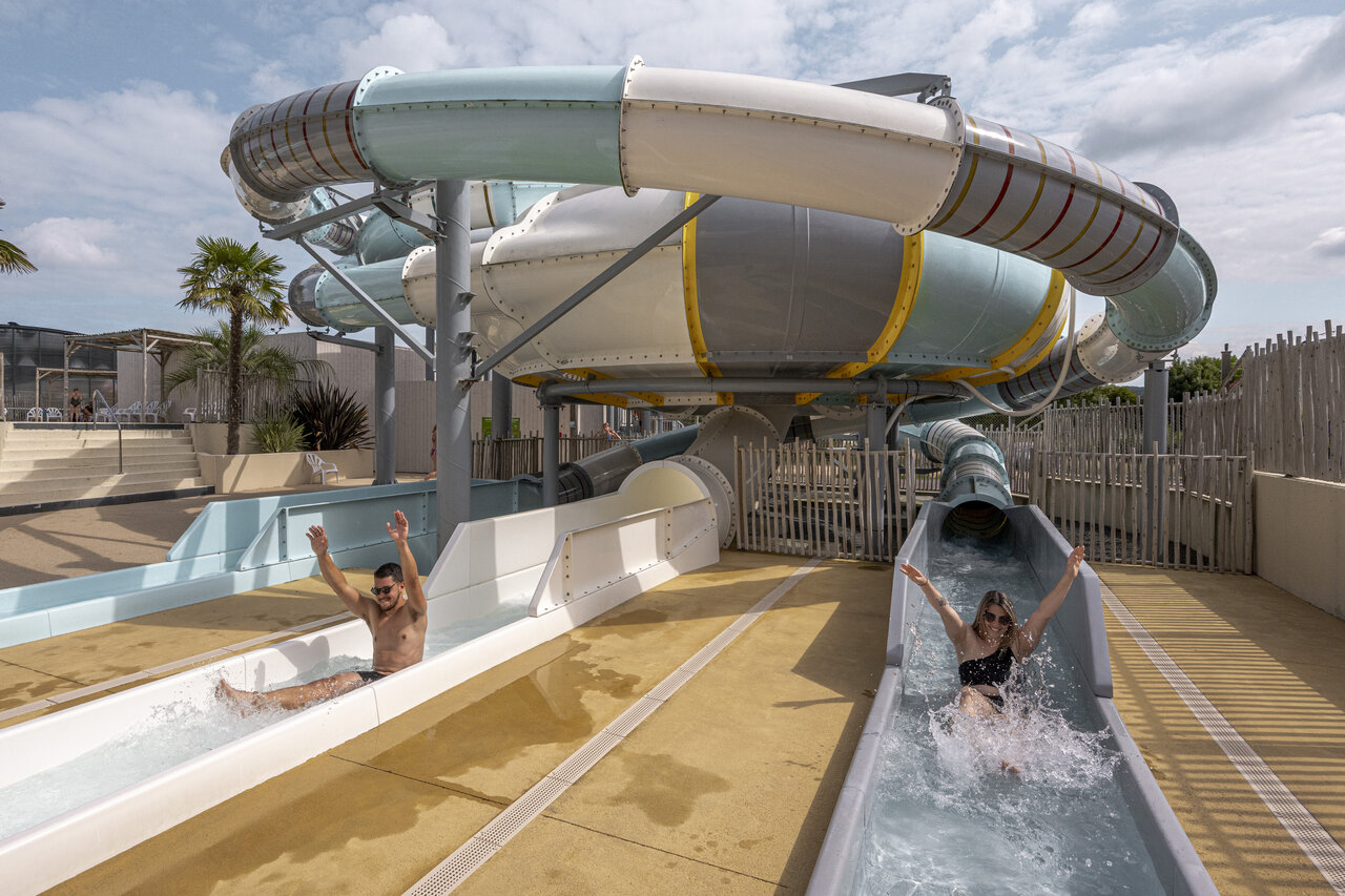 Giant water slides and people having fun at CLICOCHIC Chevaliers campsite in HOULGATE (14).