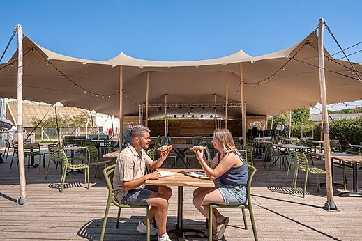Restaurant terrace under tent at CLICOCHIC Chevaliers campsite in HOULGATE.