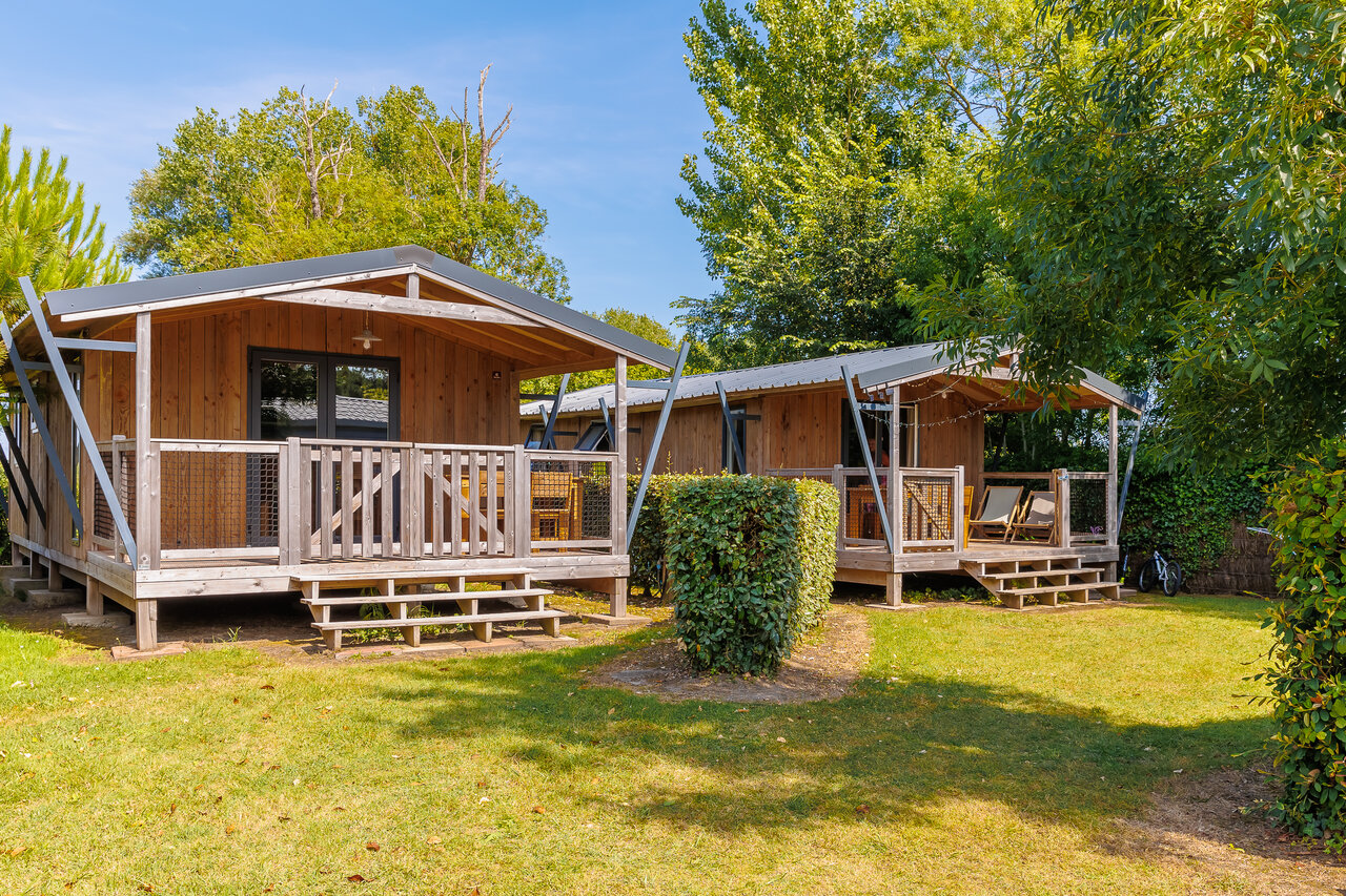 Wooden chalets with terraces at CLICOCHIC Chouans campsite in Saint Hilaire de Riez.