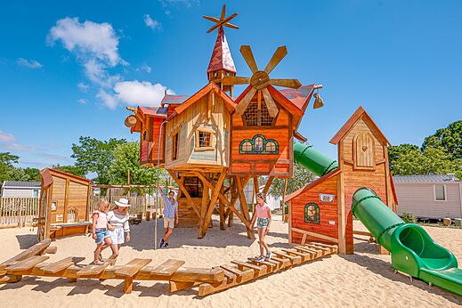 Large wooden playground with slides at CLICOCHIC Chouans campsite in SAINT HILAIRE DE RIEZ.