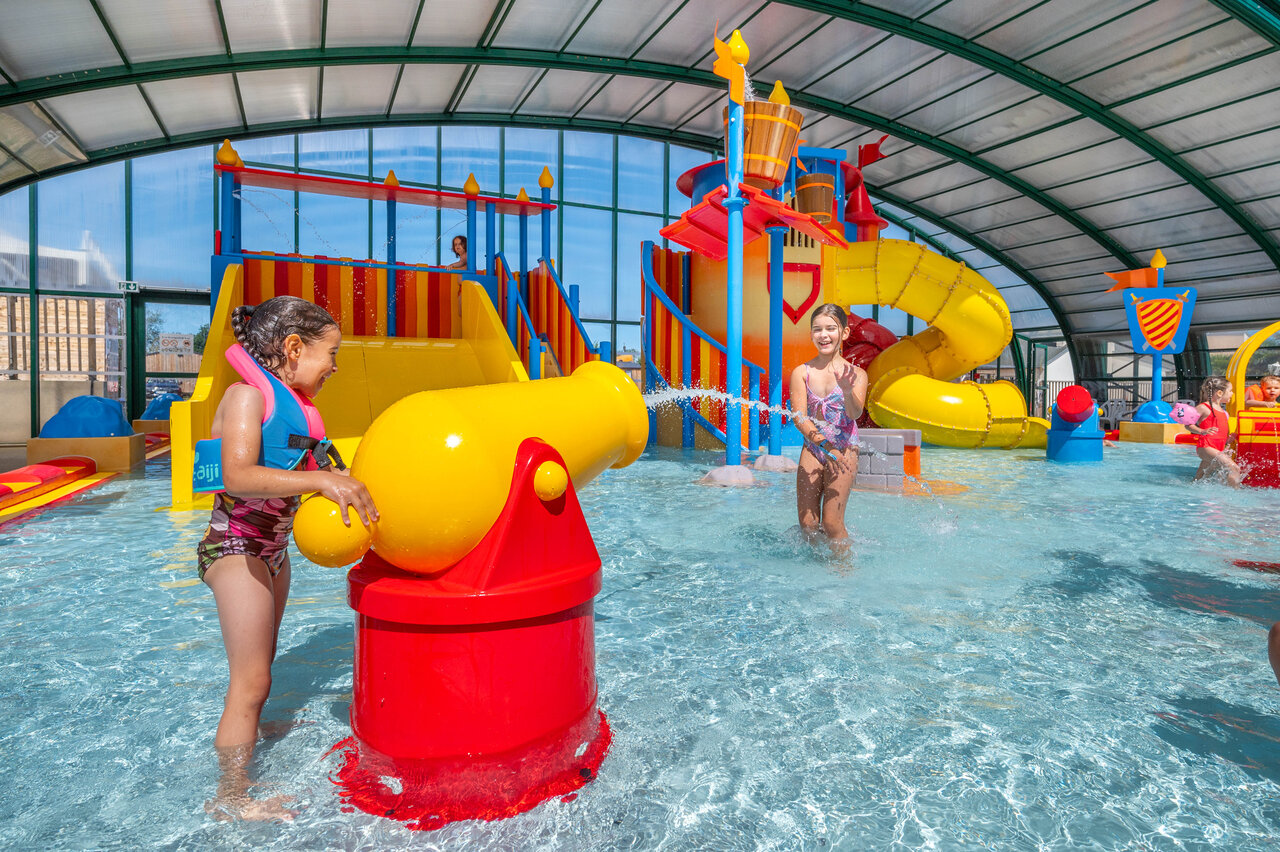 Indoor pool, slides and water games at CAPFUN Citadelle de Loustic campsite in Hermanville sur Mer.