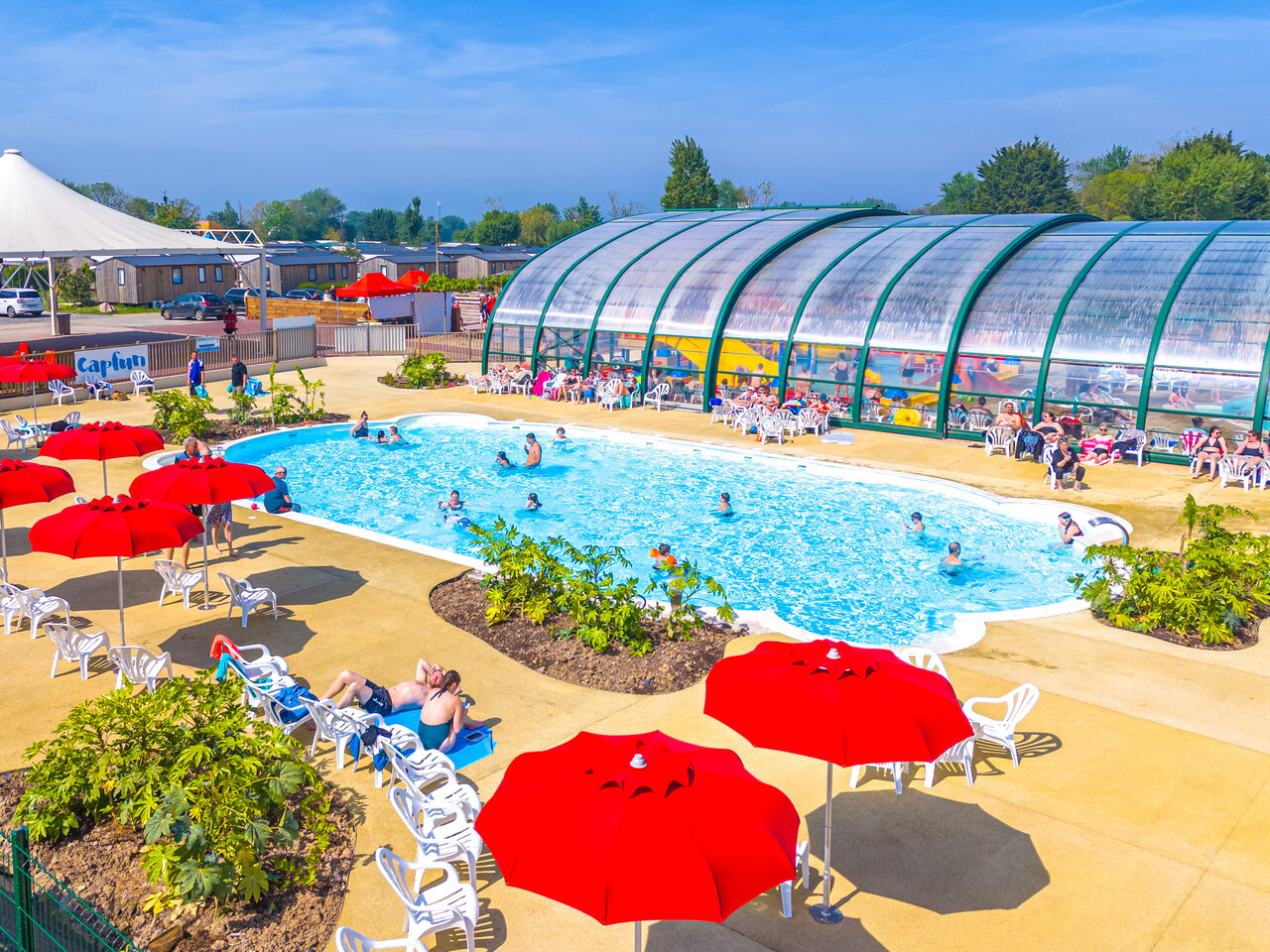 Outdoor pool, covered water park at CAPFUN Citadelle de Loustic campsite in Hermanville sur Mer.