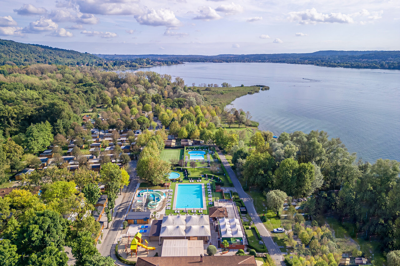 Pools, slides, accommodations, lake, aerial view at CAPFUN Citta di Angera, Angera.