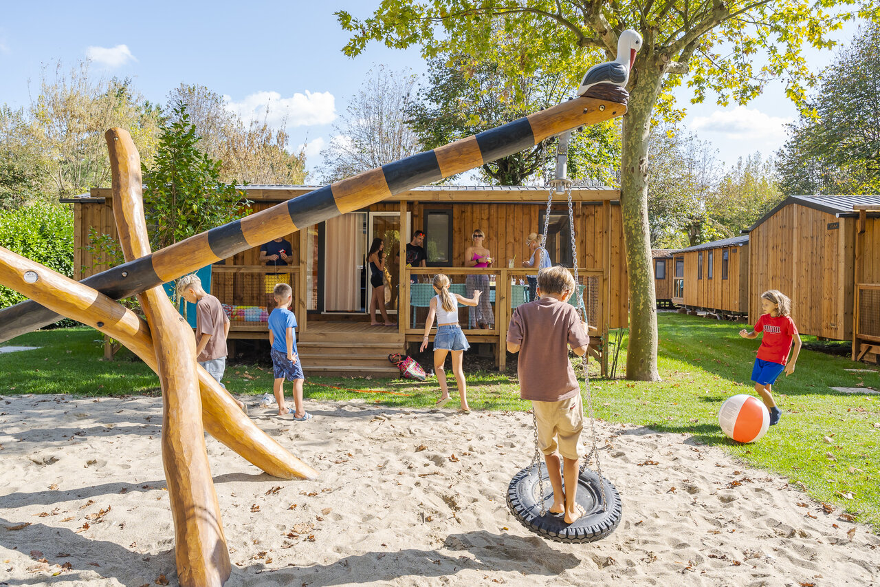Children's playground and mobile homes at CAPFUN Citta di Angera campsite in Angera VA.