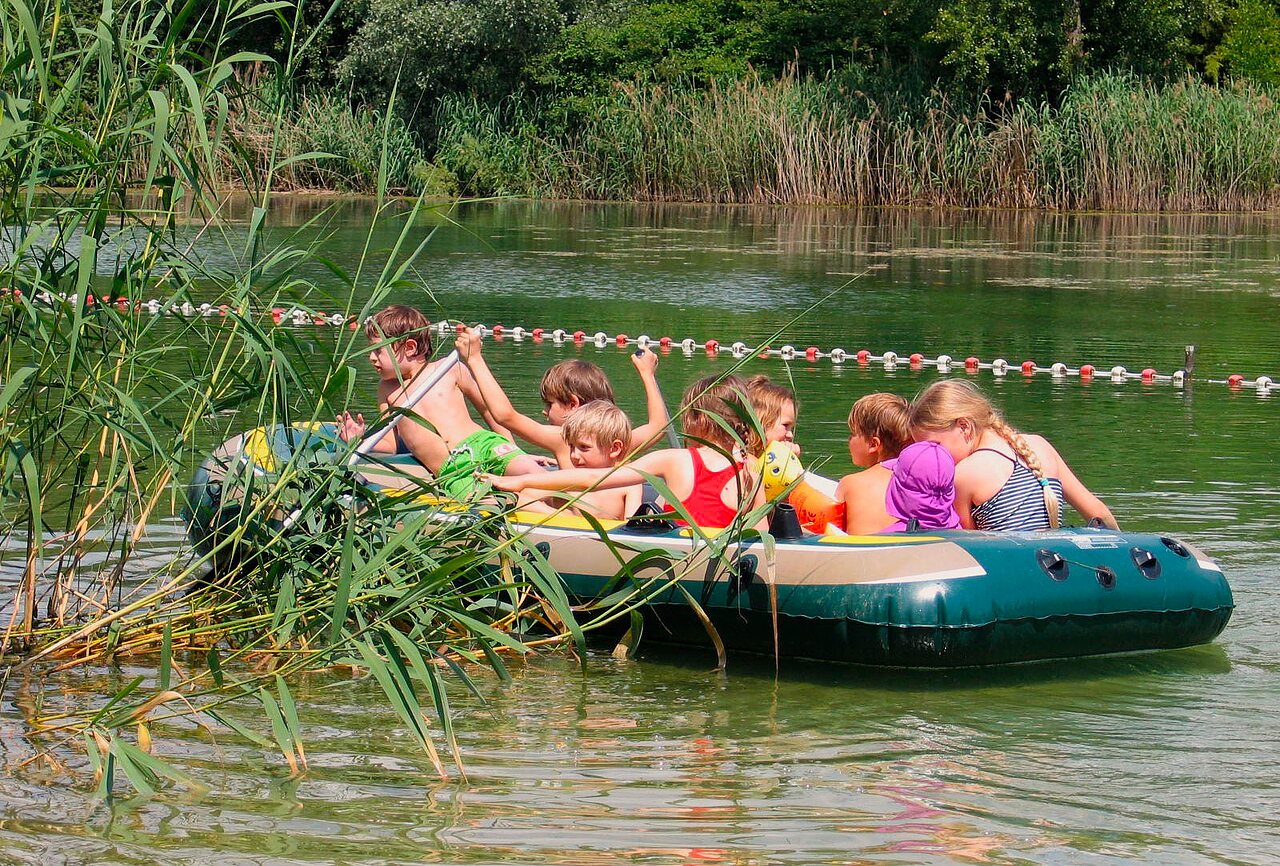 Water activities, children in boat at CLICOCHIC campsite in Gerstheim (67).