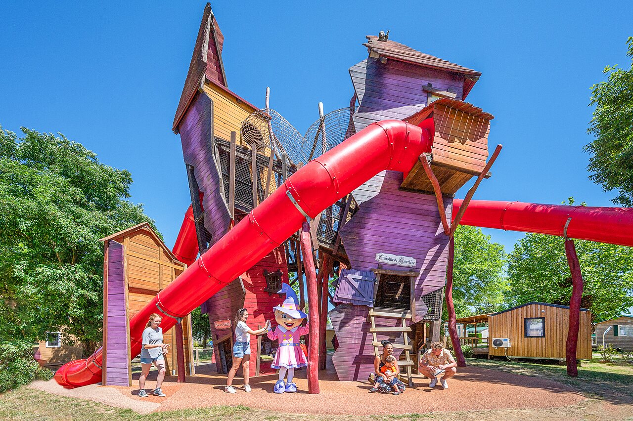 Themed playground with slides, children and mascot at CAPFUN Curty's campsite in Jard sur Mer (85).