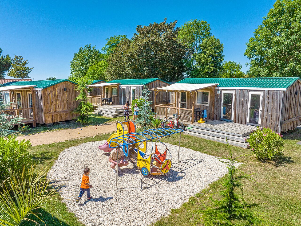 Wooden mobile homes, children's playground at CAPFUN Curty's Jard sur Mer (85).