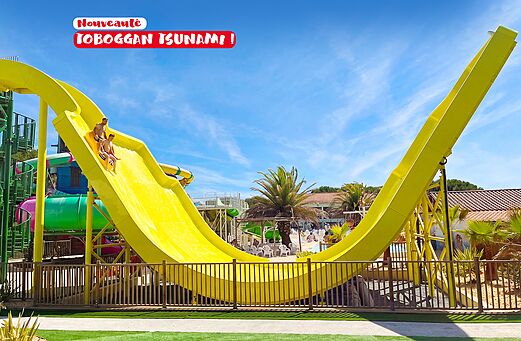 Yellow Tsunami water slide with swimmers at CAPFUN Curty's campsite Jard sur Mer.