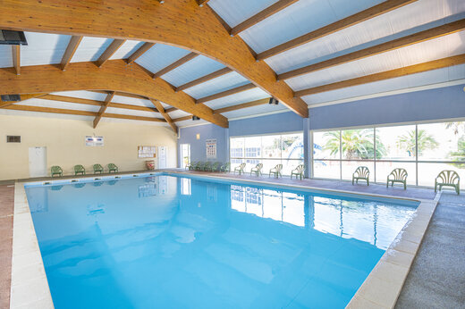 Indoor covered pool, wooden frame, large windows at CAPFUN Dauphins Bleus GIVRAND.