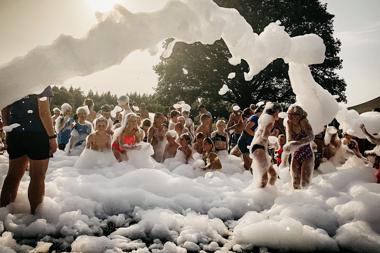 Lively foam party with happy children at CAPFUN De Belten campsite in Rheeze.