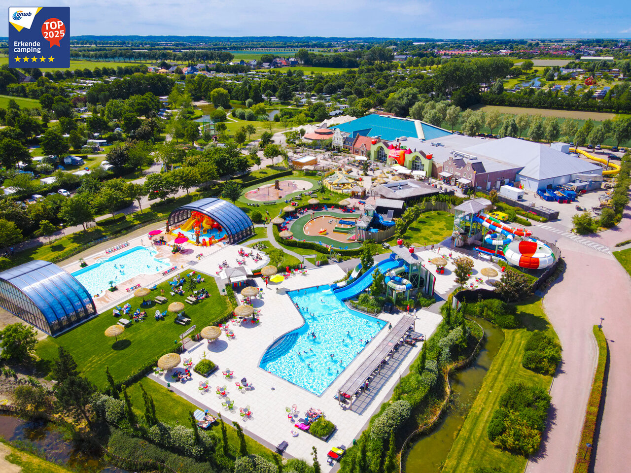 Water park, swimming pools, slides seen from sky at CAPFUN De Bongerd campsite in Tuitjenhorn.