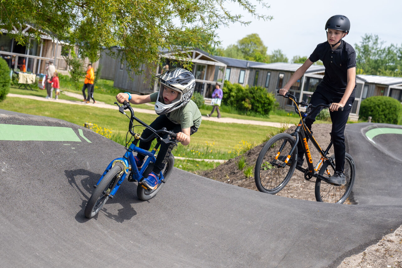 Children on the pump track at CAPFUN De Bongerd campsite in Tuitjenhorn.