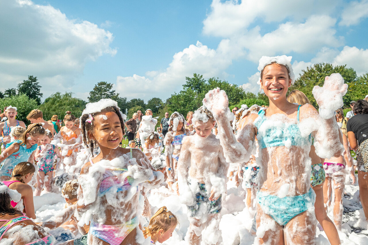 Happy children at the foam party at CAPFUN De Bongerd campsite in Tuitjenhorn.