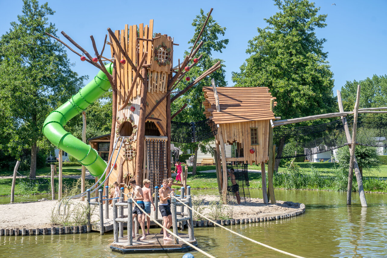 Water slide, treehouse and playground at CAPFUN De Bongerd campsite in Tuitjenhorn.