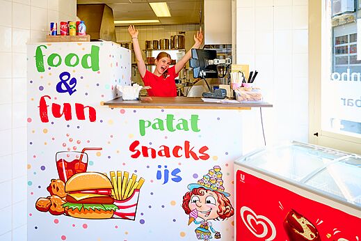 Colorful snack bar counter with smiling employee at CAPFUN De Eikenhof campsite in Paasloo/Oldemarkt.