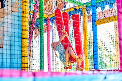 Colorful indoor play area with child on obstacle course at CAPFUN De Eikenhof campsite in Paasloo/Oldemarkt.