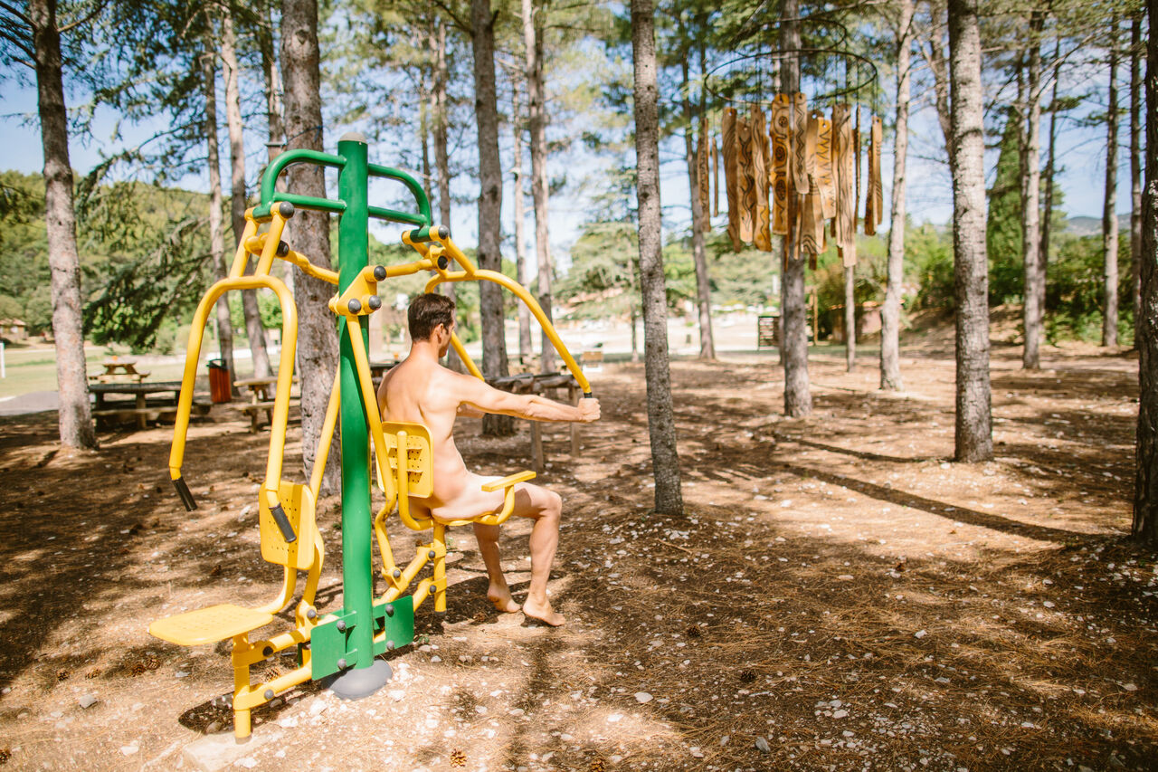Naturist man using outdoor fitness equipment at LIBRANOO Naturiste Belezy campsite in B�doin (84).
