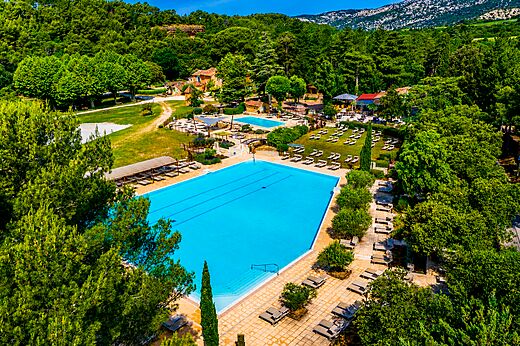 Large aquatic complex with multiple swimming pools from aerial view at LIBRANOO Naturiste Belezy campsite in Bédoin (84).
