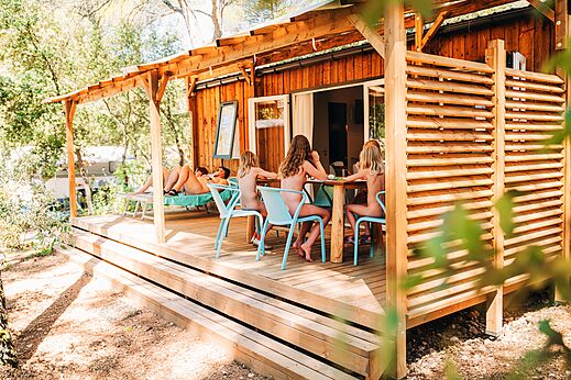 Naturist family on the Mobil-home terrace at LIBRANOO Naturiste Belezy campsite in Bédoin (84).