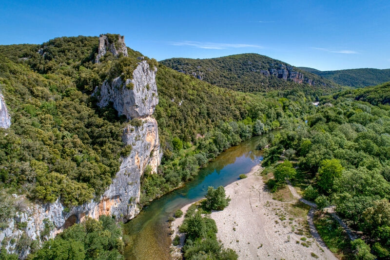 River, rocky cliffs and forest, aerial view at LIBRANOO Naturiste Sabliere campsite.
