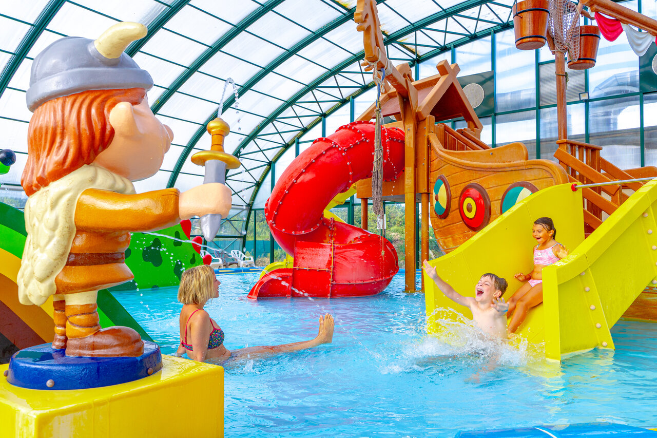 Indoor pool, water slides and Viking games at CAPFUN Donjon de Lars campsite.