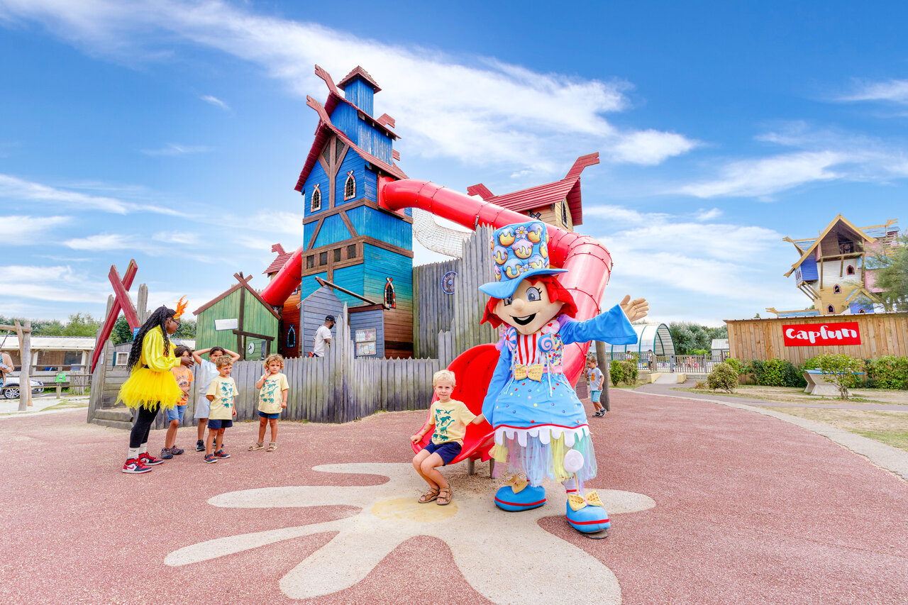 Playground, slides, mascots, children at CAPFUN Donjon de Lars campsite in Courseulles-sur-Mer.
