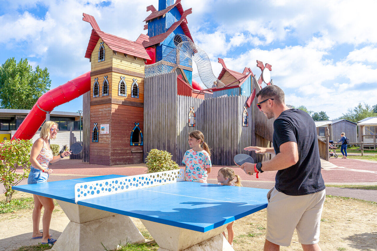 Family playing table tennis, playground, CAPFUN Donjon de Lars.