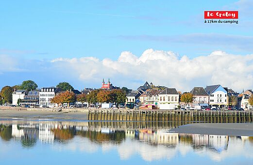 Le Crotoy, charming port town with colorful houses and reflections on water.