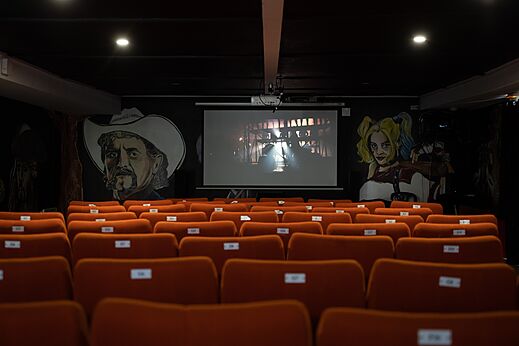 Cinema room with large screen and comfortable seats at CAPFUN Dune Fleurie campsite.